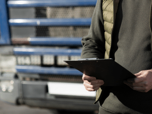 A man counting cargo number infront of a container truck. cargo security counting number.jpg