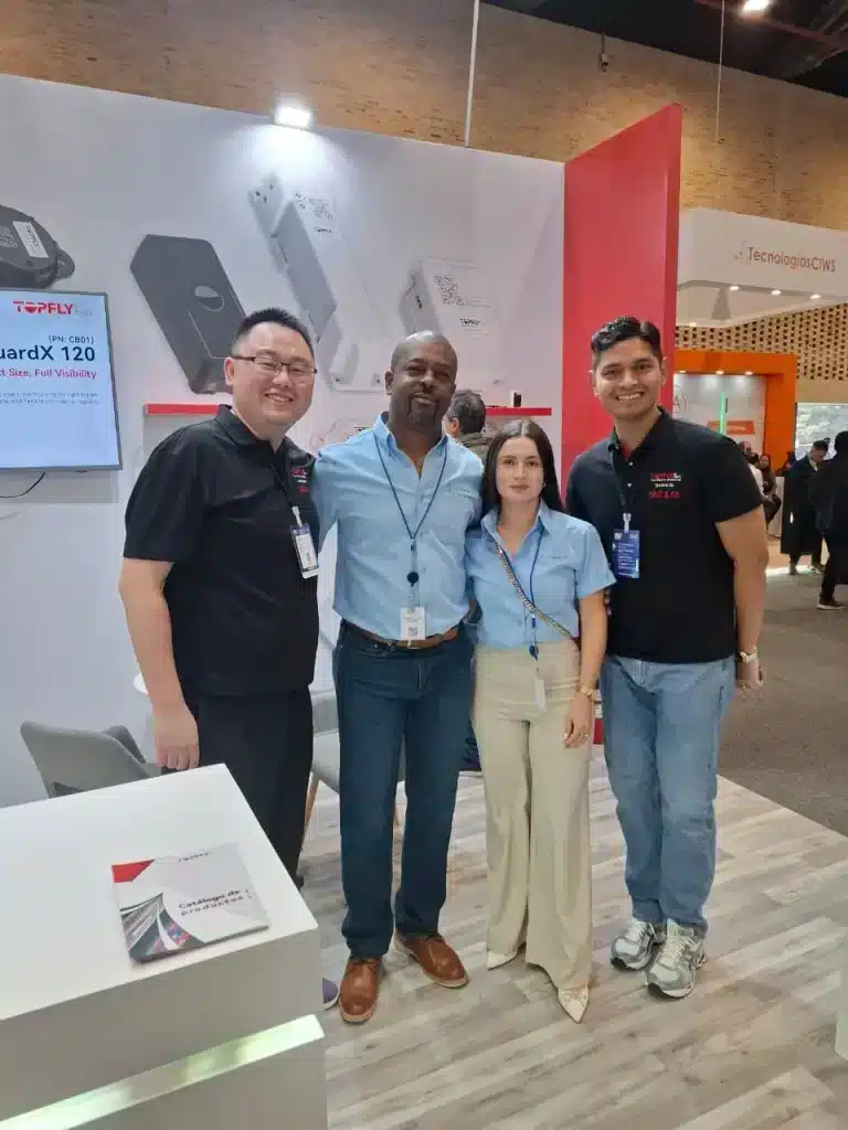 TOPFLYtech team with ESS+ representatives during the ESS+ 2026 security and technology exhibition in Bogotá, Colombia.